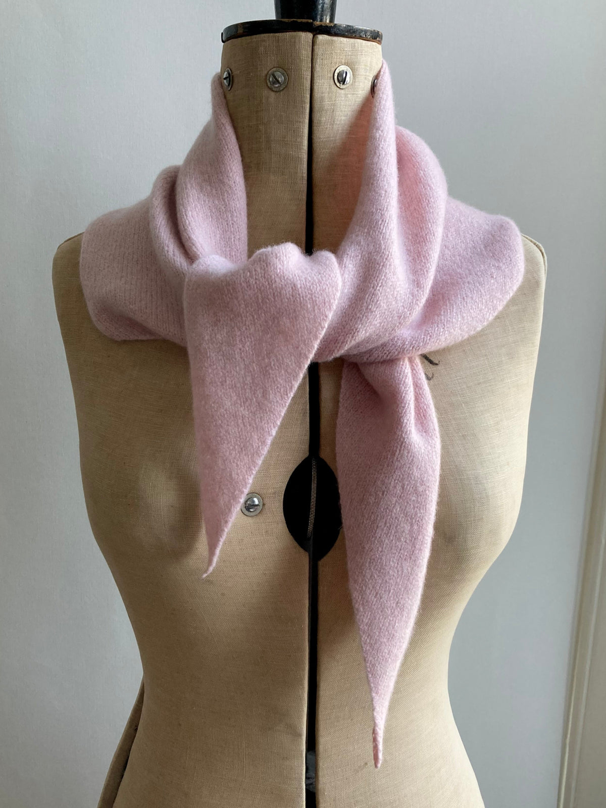 Pale pink neckerchief scarf styled on a mannequin.