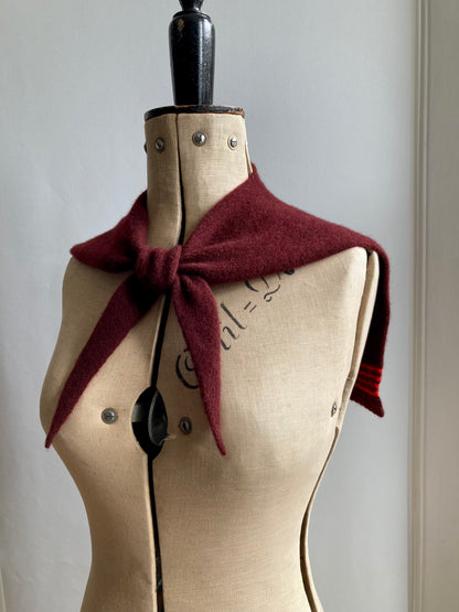 Mannequin wearing a knitted red brown sailor collar with red stripes, wool scarf.