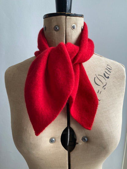 Bright red knitted neck tie scarf tied on a mannequin.