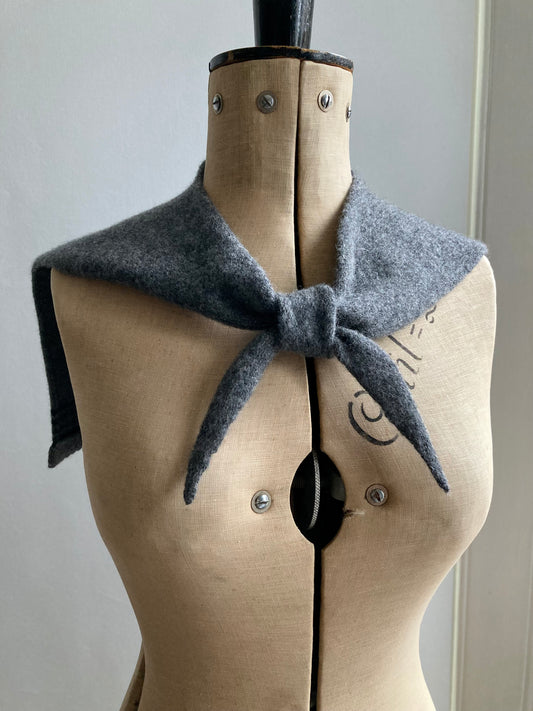 Dark grey sailor collar knitted scarf with black stripes shown on a mannequin.