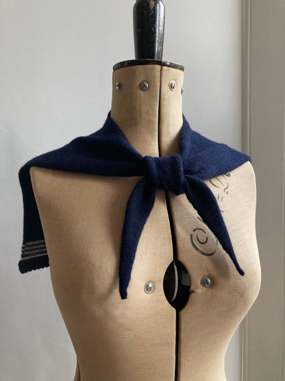 Dark navy sailor collar scarf with white stripes tied on a mannequin.
