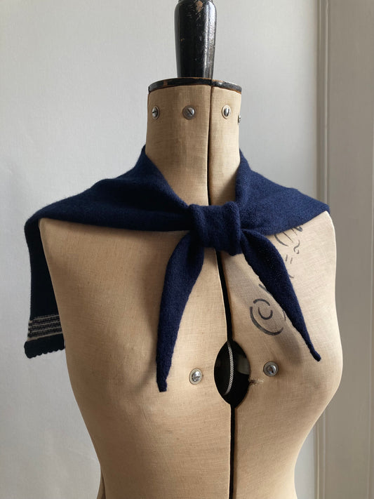 Dark navy sailor collar scarf with white stripes tied on a mannequin.